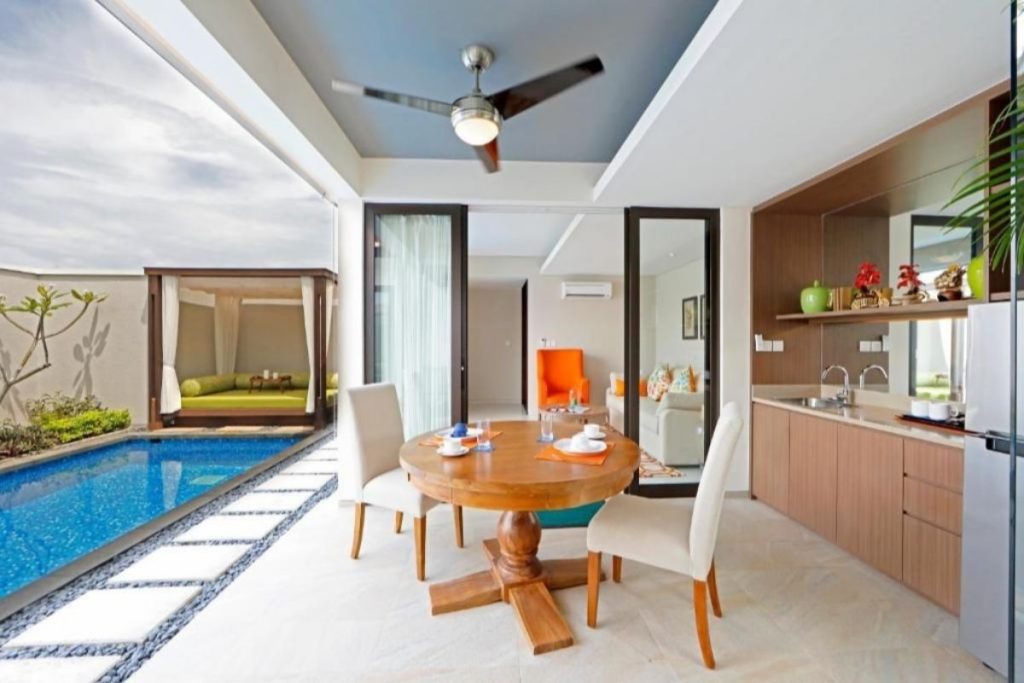 Villa dining area with pool view at Pantai Indah Lagoi Bintan