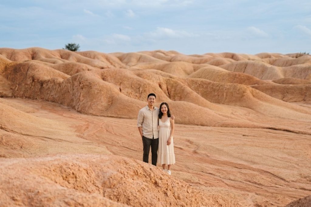 Couple taking photos at Bintan Sand Dunes during a full day tour after early ferry arrival from Singapore