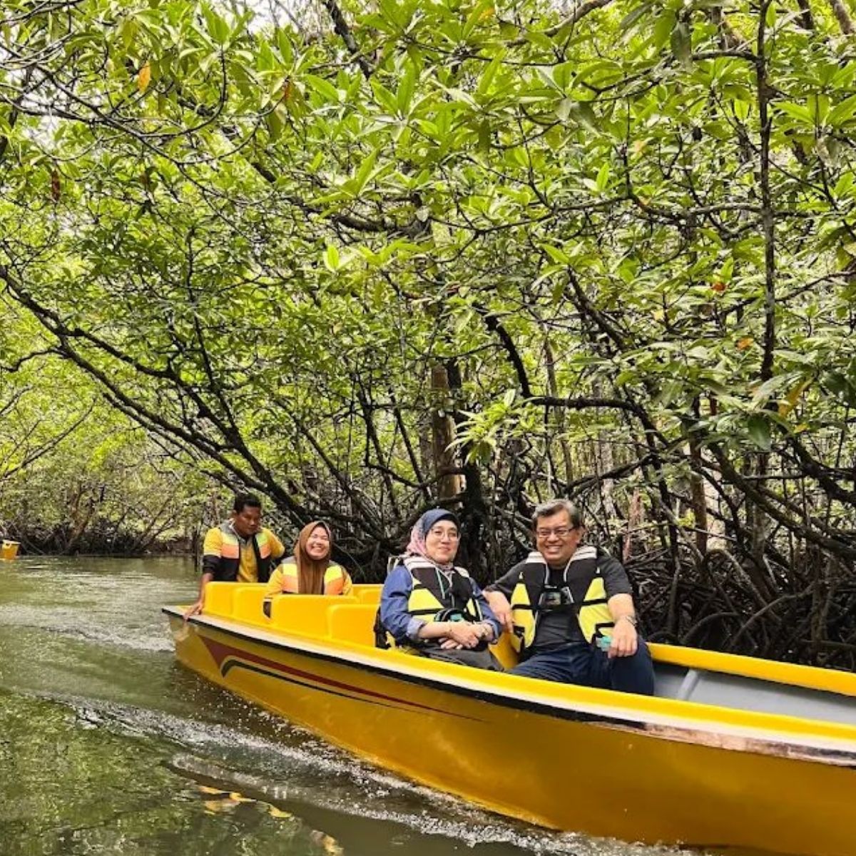 Couple on mangrove boat tour Sebung River Bintan enjoying nature experience